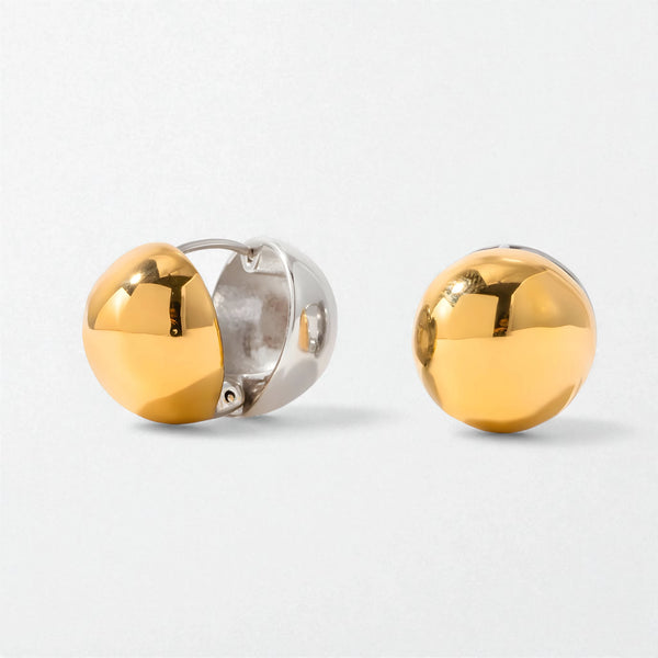 Pair of Orla chunky two-tone sphere huggies in duo tone stainless steel: a silver hinged hoop with a polished gold ball