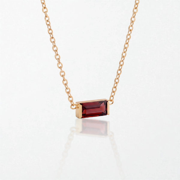 Juno birthstone necklace in 14K gold-plated waterproof stainless steel with a small baguette garnet red stone for January