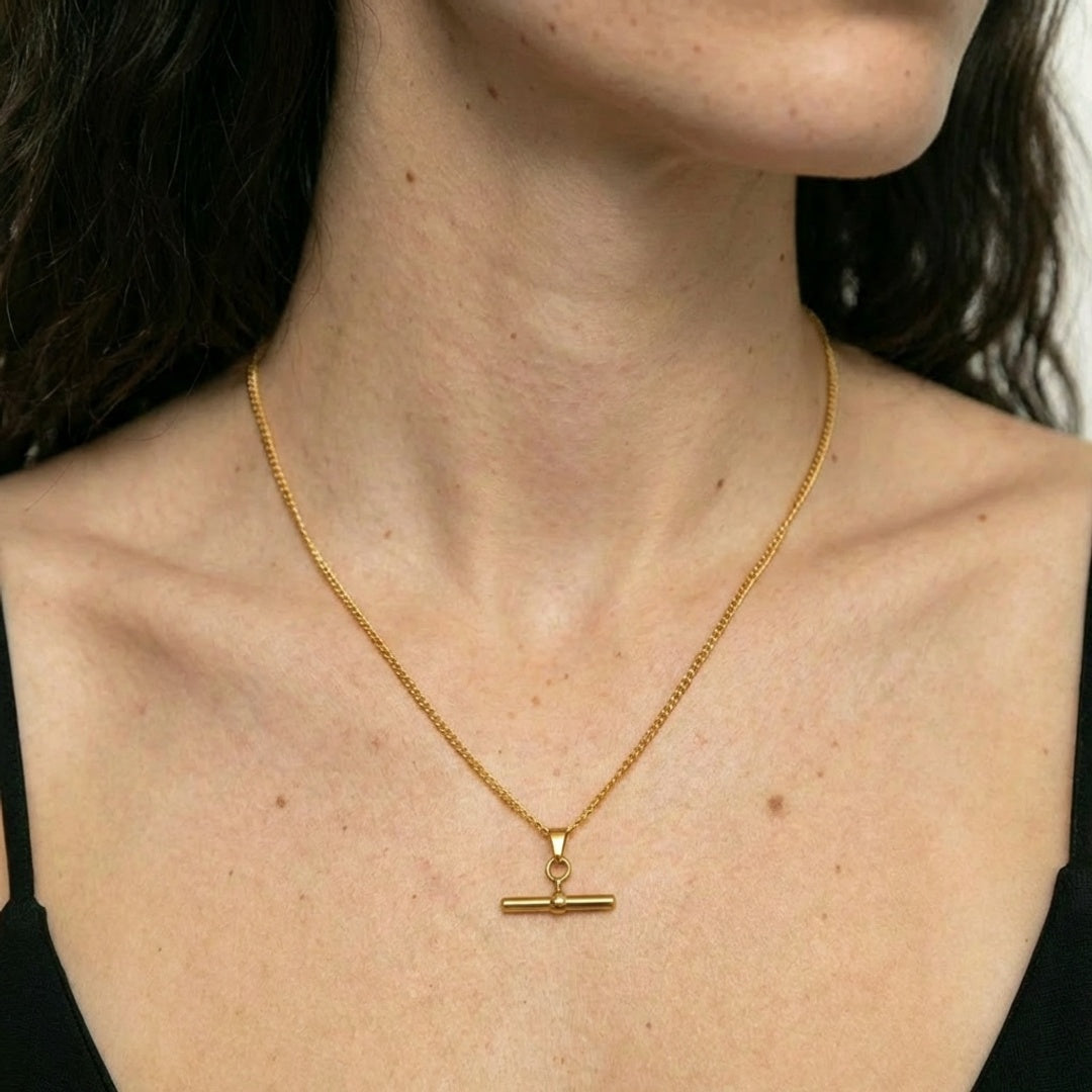 Minimalist T-bar necklace in 18K gold plated stainless steel, worn on model