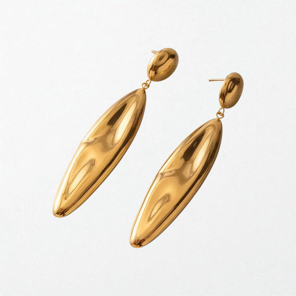 Pair of Linnea sculptural molten drop earrings in 18K gold-plated waterproof stainless steel, a glossy gold ball above a long slim drop