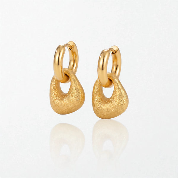 Pair of Agnes textured molten drop huggies in 18K gold-plated waterproof stainless steel, with a brushed, rounded drop under a hoop