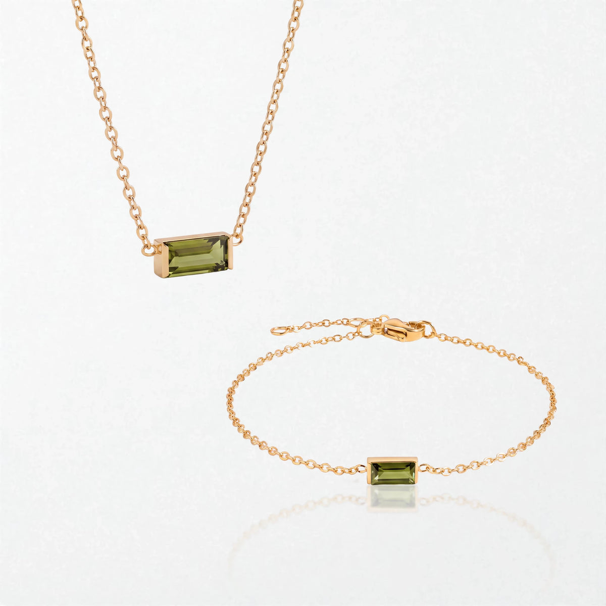 The Juno birthstone set for August: matching necklace and bracelet with peridot green baguette stones, in 14K gold-plated waterproof stainless steel