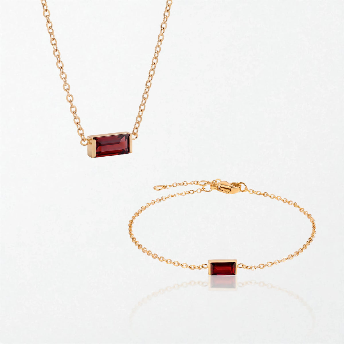 The Juno birthstone set for January: matching necklace and bracelet with garnet red baguette stones, in 14K gold-plated waterproof stainless steel