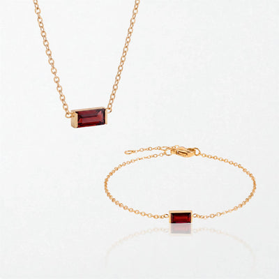 The Juno birthstone set for January: matching necklace and bracelet with garnet red baguette stones, in 14K gold-plated waterproof stainless steel