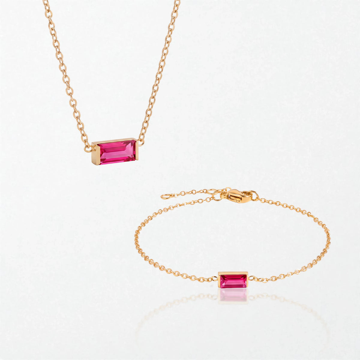 The Juno birthstone set for July: matching necklace and bracelet with ruby red baguette stones, in 14K gold-plated waterproof stainless steel