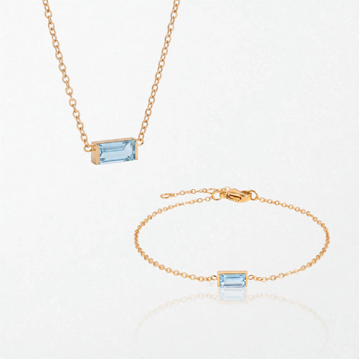 The Juno birthstone set for March: matching necklace and bracelet with aquamarine blue baguette stones, in 14K gold-plated waterproof stainless steel
