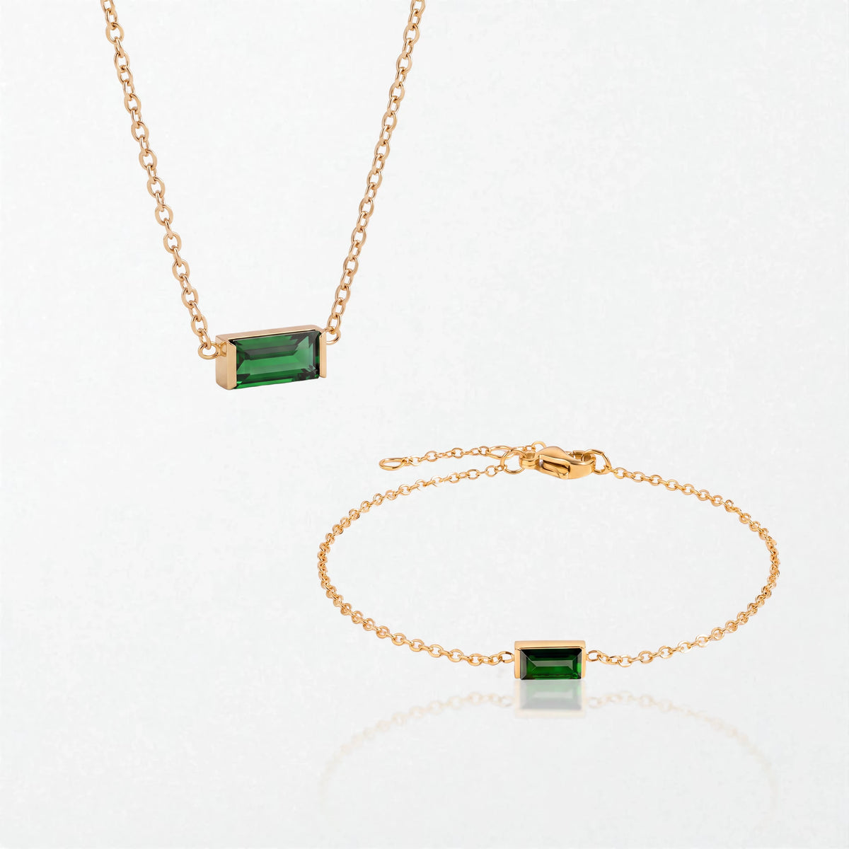 The Juno birthstone set for May: matching necklace and bracelet with emerald green baguette stones, in 14K gold-plated waterproof stainless steel