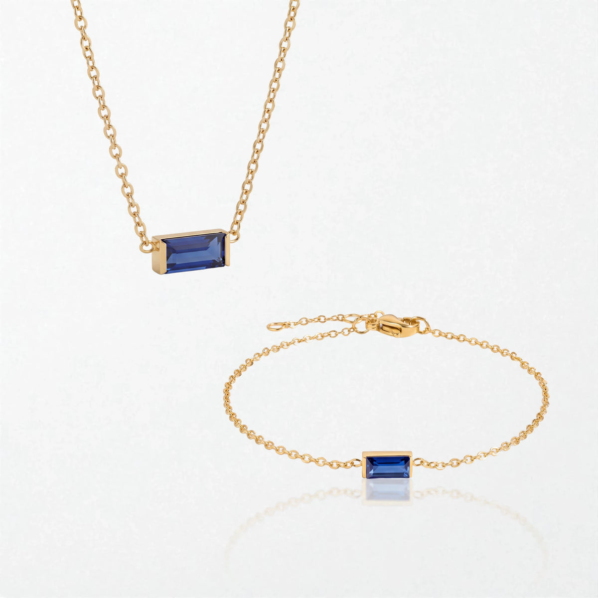 The Juno birthstone set for September: matching necklace and bracelet with sapphire blue baguette stones, in 14K gold-plated waterproof stainless steel