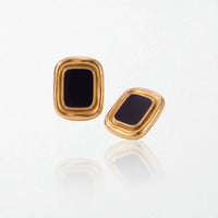 Pair of Sabine statement stud earrings: glossy black rectangular panels in thick, rounded 18K gold-plated stainless steel frames