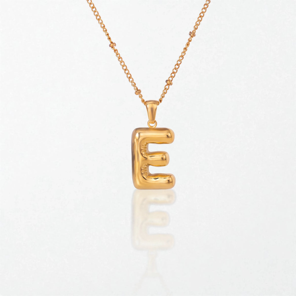 Bubble initial necklace with letter E pendant in 18K gold plated stainless steel, on a satellite chain