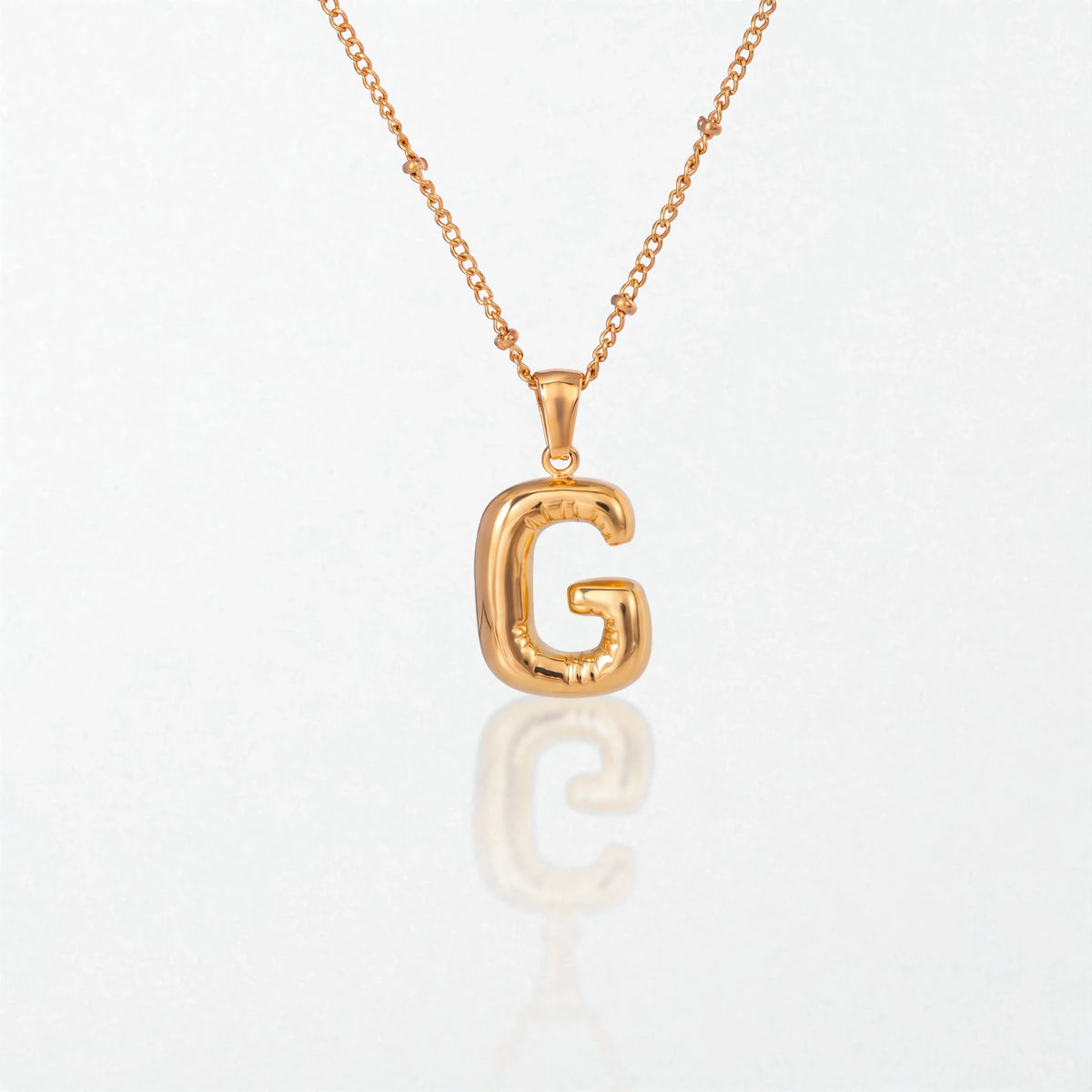 Bubble initial necklace with letter G pendant in 18K gold plated stainless steel, on a satellite chain