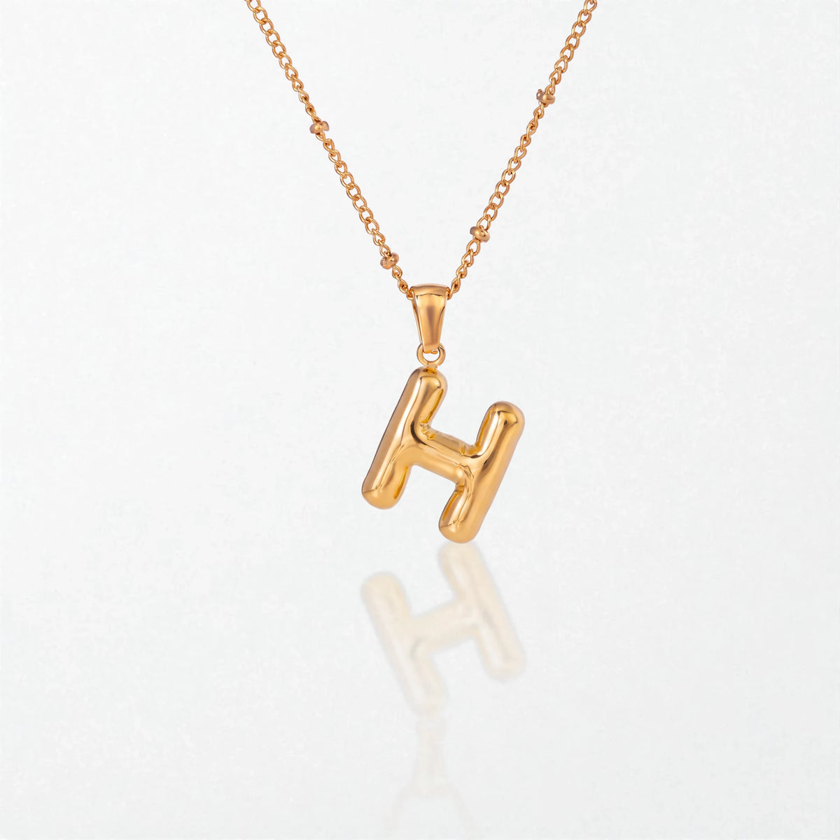 Bubble initial necklace with letter H pendant in 18K gold plated stainless steel, on a satellite chain