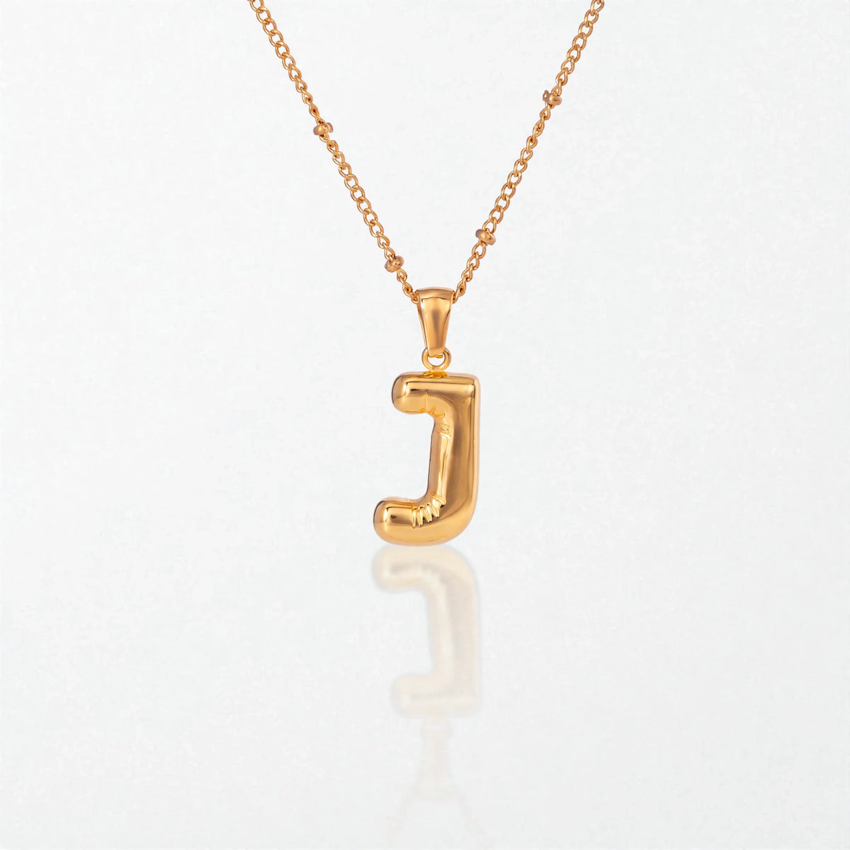 Bubble initial necklace with letter J pendant in 18K gold plated stainless steel, on a satellite chain