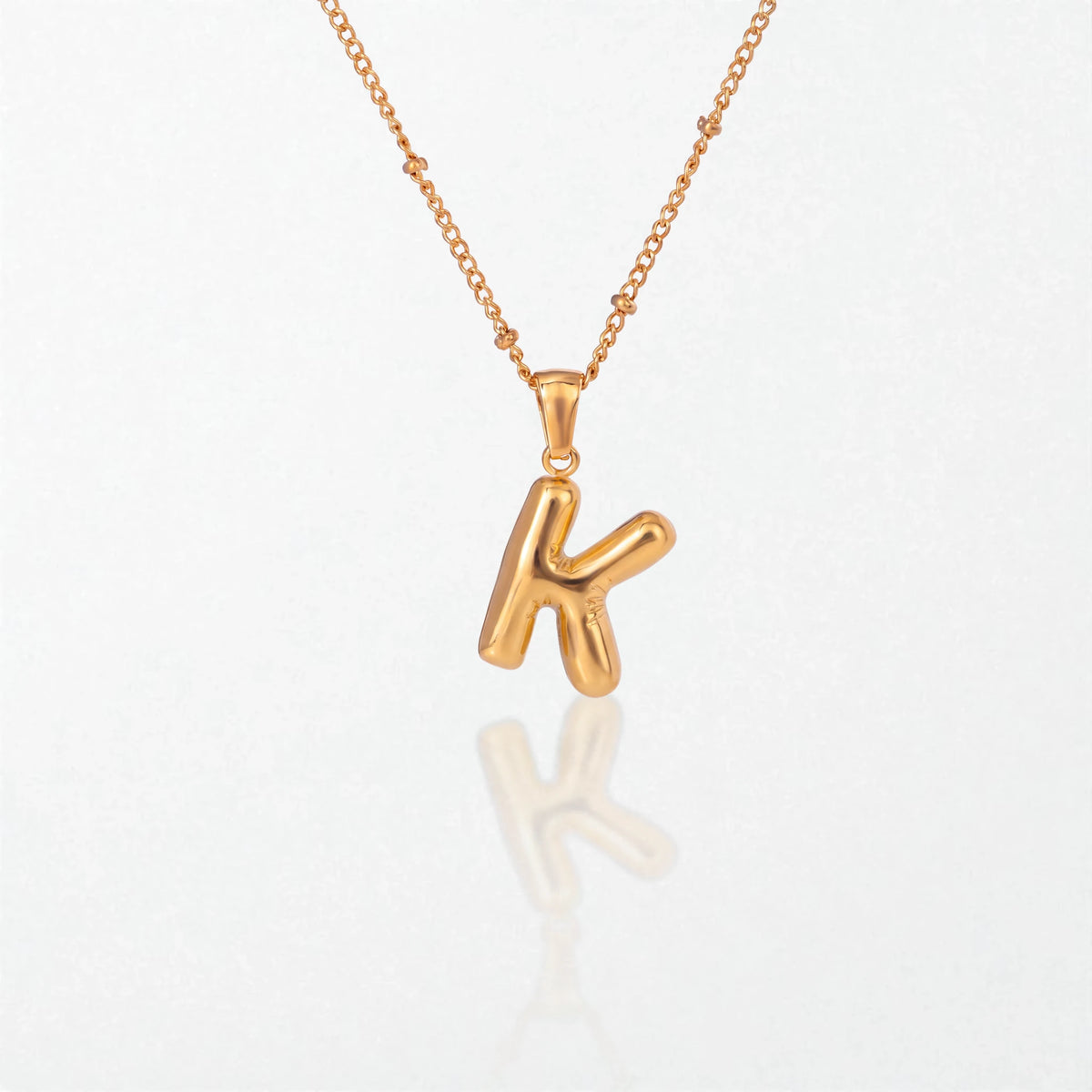Bubble initial necklace with letter K pendant in 18K gold plated stainless steel, on a satellite chain