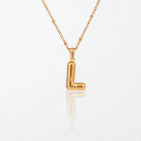 Bubble initial necklace with letter L pendant in 18K gold plated stainless steel, on a satellite chain