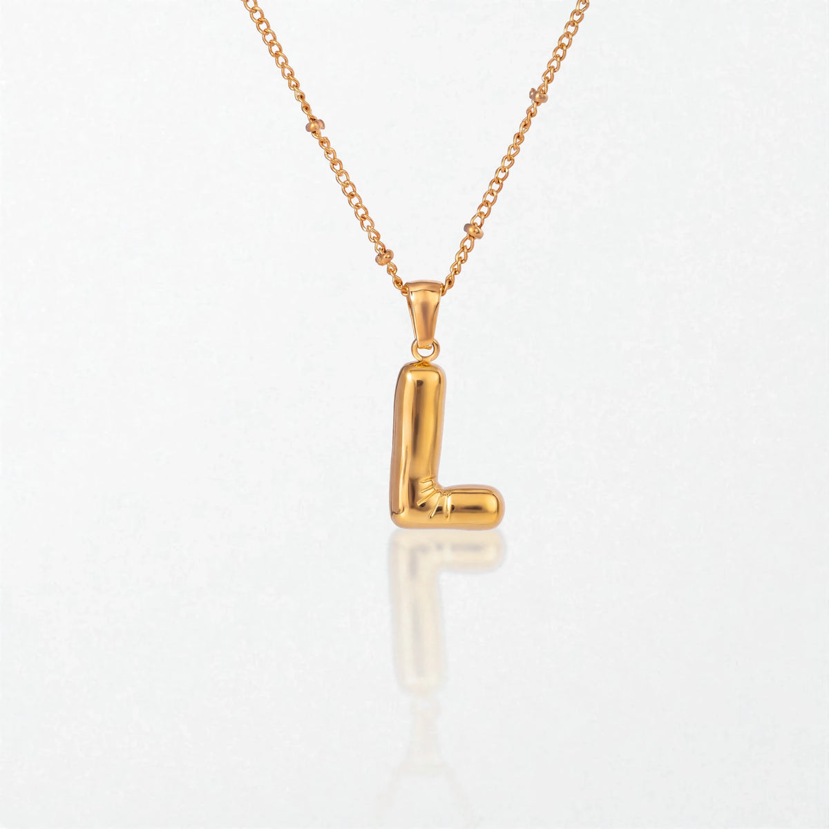 Bubble initial necklace with letter L pendant in 18K gold plated stainless steel, on a satellite chain