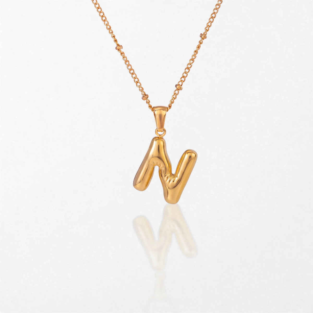 Bubble initial necklace with letter N pendant in 18K gold plated stainless steel, on a satellite chain
