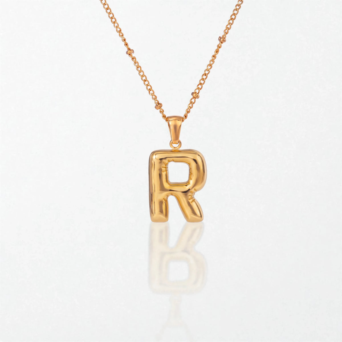 Bubble initial necklace with letter R pendant in 18K gold plated stainless steel, on a satellite chain