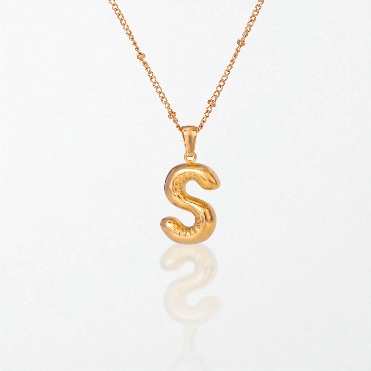 Bubble initial necklace with letter S pendant in 18K gold plated stainless steel, on a satellite chain