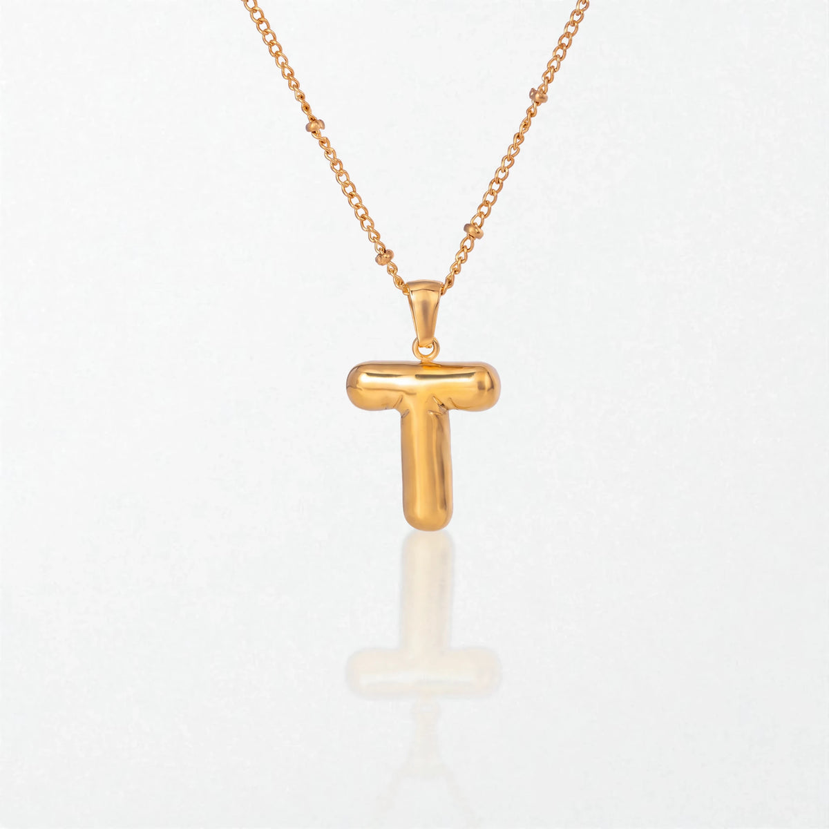 Bubble initial necklace with letter T pendant in 18K gold plated stainless steel, on a satellite chain