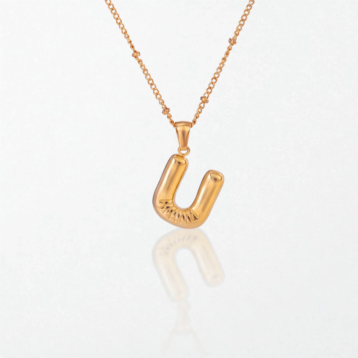 Bubble initial necklace with letter U pendant in 18K gold plated stainless steel, on a satellite chain
