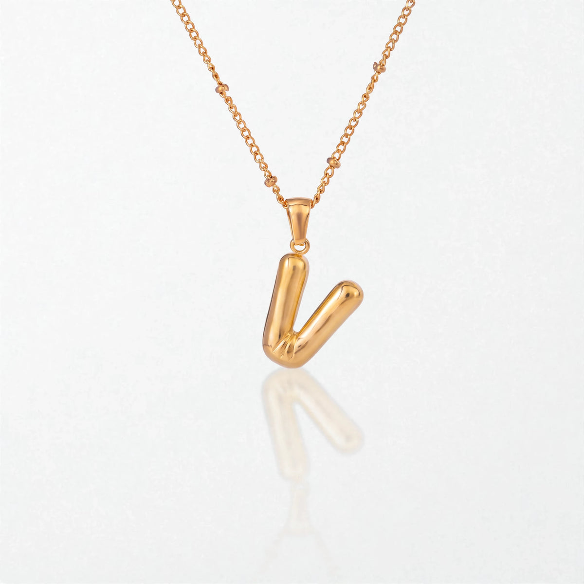 Bubble initial necklace with letter V pendant in 18K gold plated stainless steel, on a satellite chain
