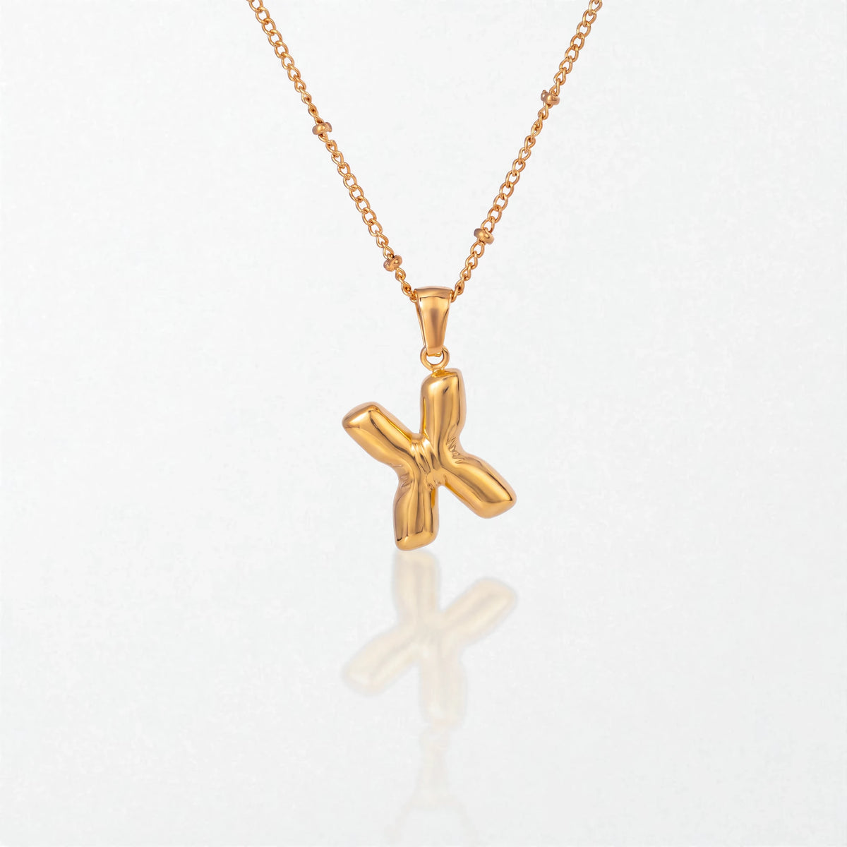 Bubble initial necklace with letter X pendant in 18K gold plated stainless steel, on a satellite chain