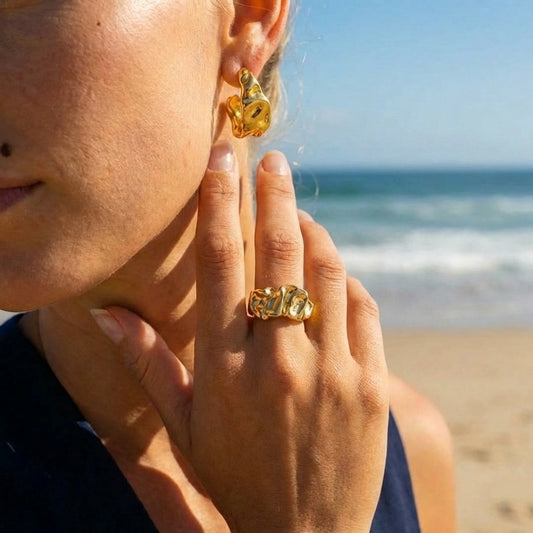 Chunky molten ring and open hoop earrings in 18K gold plated stainless steel, worn on model