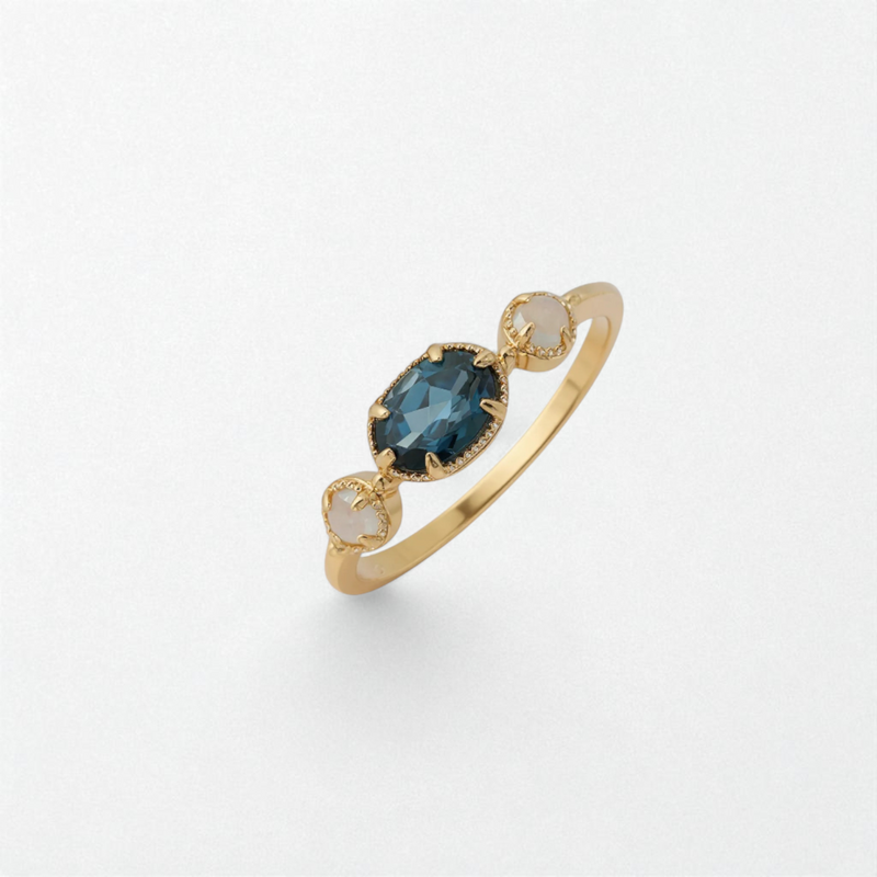 Gold coloured 925 sterling silver ring with a trio of marquise-cut blue topaz stones