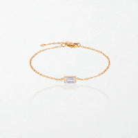 Juno birthstone bracelet in 14K gold-plated waterproof stainless steel with a small baguette clear crystal stone for April