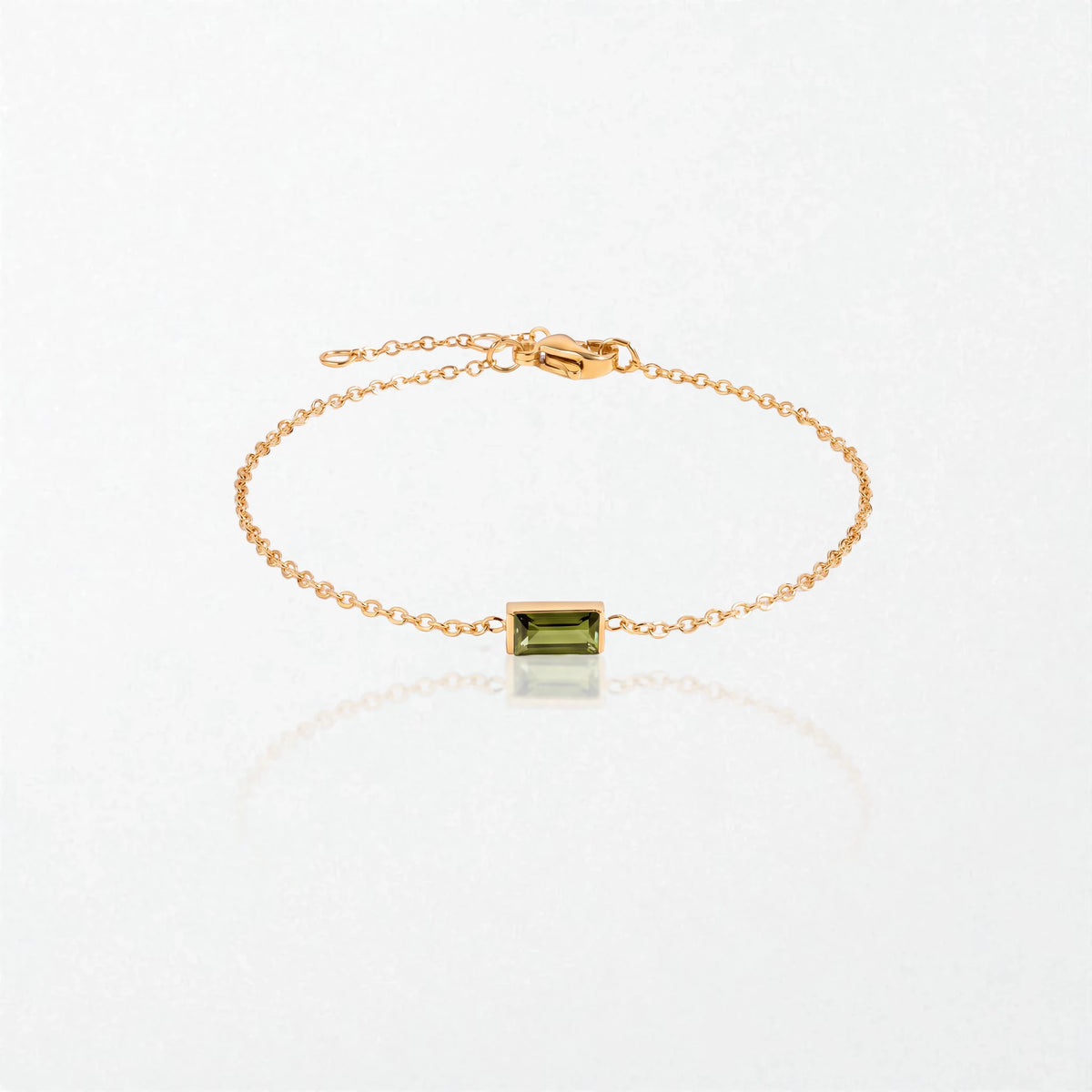 Juno birthstone bracelet in 14K gold-plated waterproof stainless steel with a small baguette peridot green stone for August