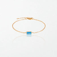 Juno birthstone bracelet in 14K gold-plated waterproof stainless steel with a small baguette blue topaz stone for December