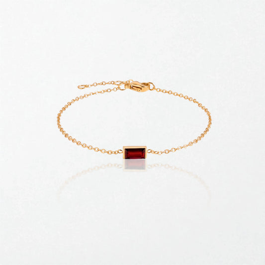 Juno birthstone bracelet in 14K gold-plated waterproof stainless steel with a small baguette garnet red stone for January