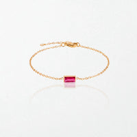 Juno birthstone bracelet in 14K gold-plated waterproof stainless steel with a small baguette ruby red stone for July