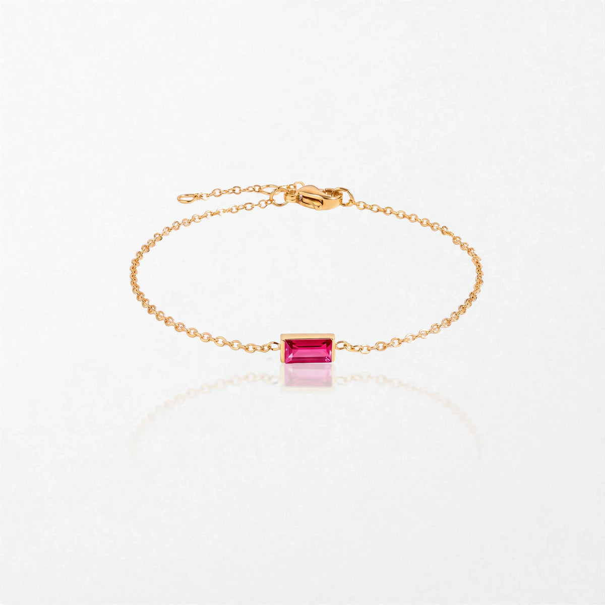 Juno birthstone bracelet in 14K gold-plated waterproof stainless steel with a small baguette ruby red stone for July
