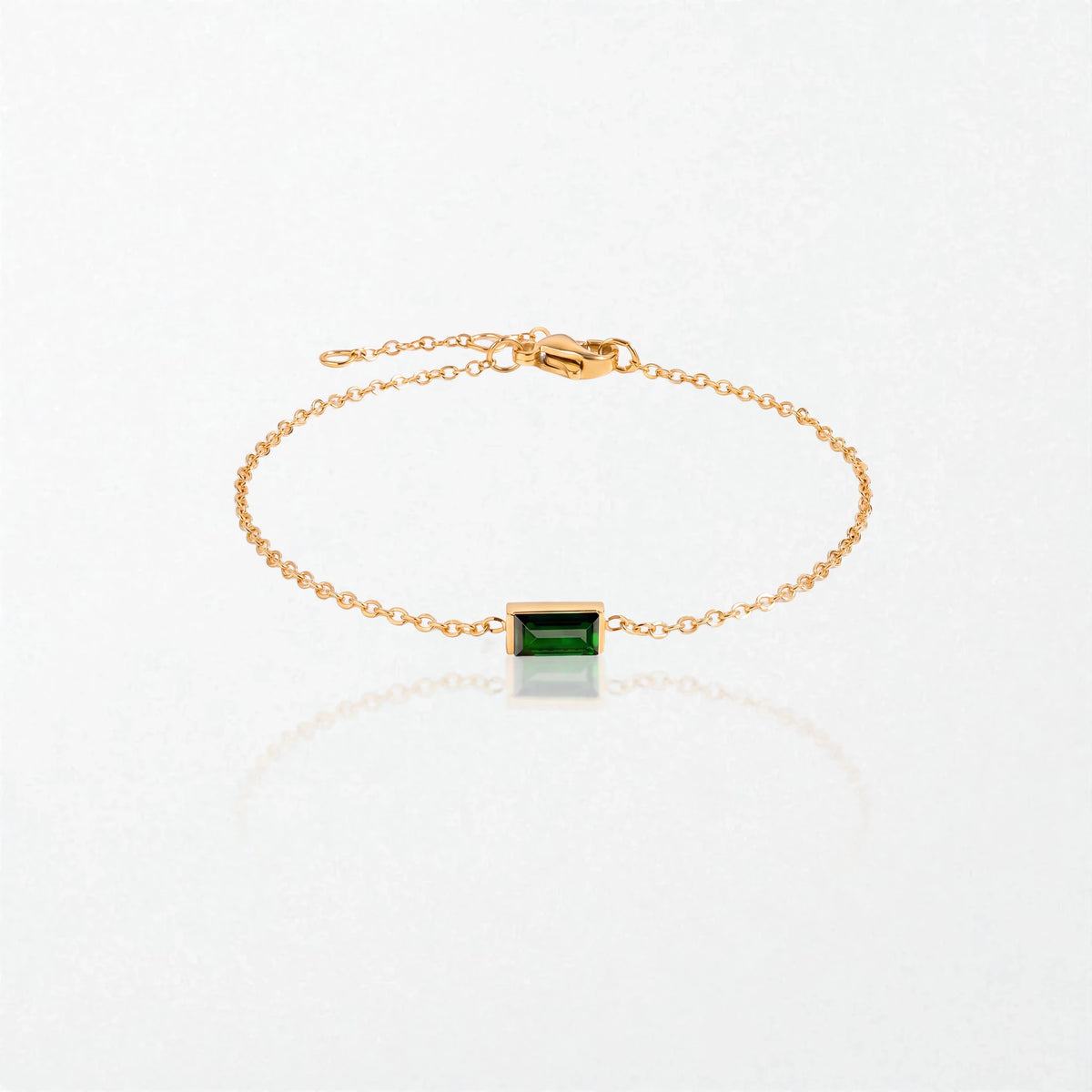 Juno birthstone bracelet in 14K gold-plated waterproof stainless steel with a small baguette emerald green stone for May