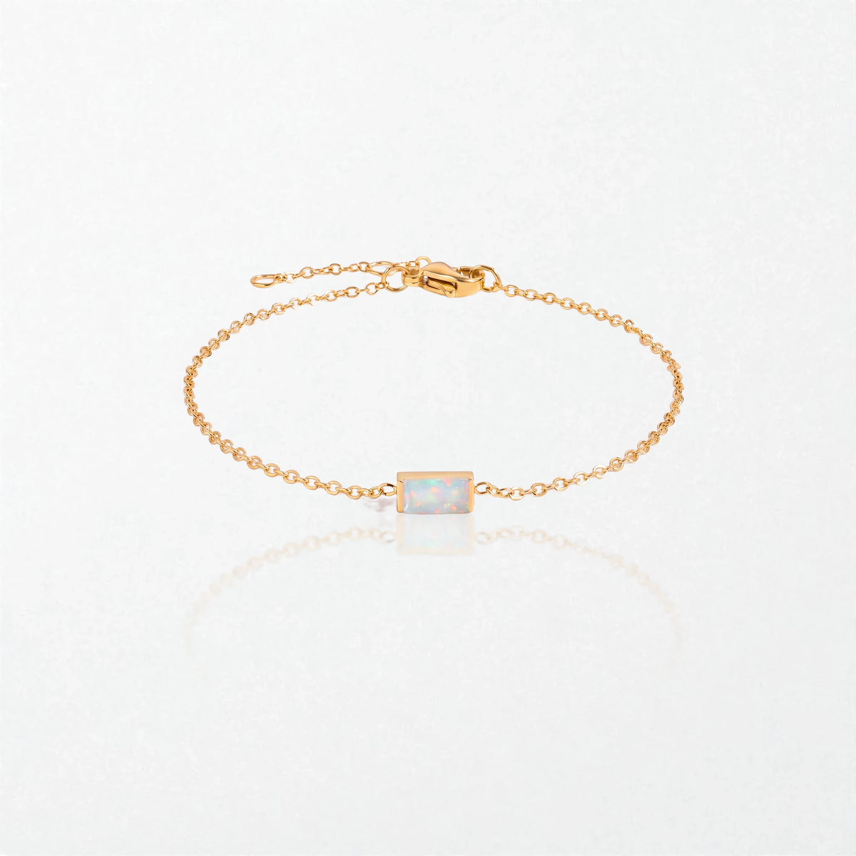 Juno birthstone bracelet in 14K gold-plated waterproof stainless steel with a small baguette opal white stone for October