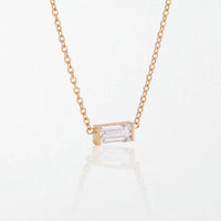 Juno birthstone necklace in 14K gold-plated waterproof stainless steel with a small baguette clear crystal stone for April