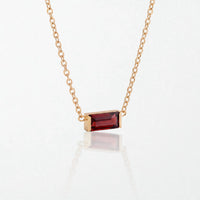 Juno birthstone necklace in 14K gold-plated waterproof stainless steel with a small baguette garnet red stone for January