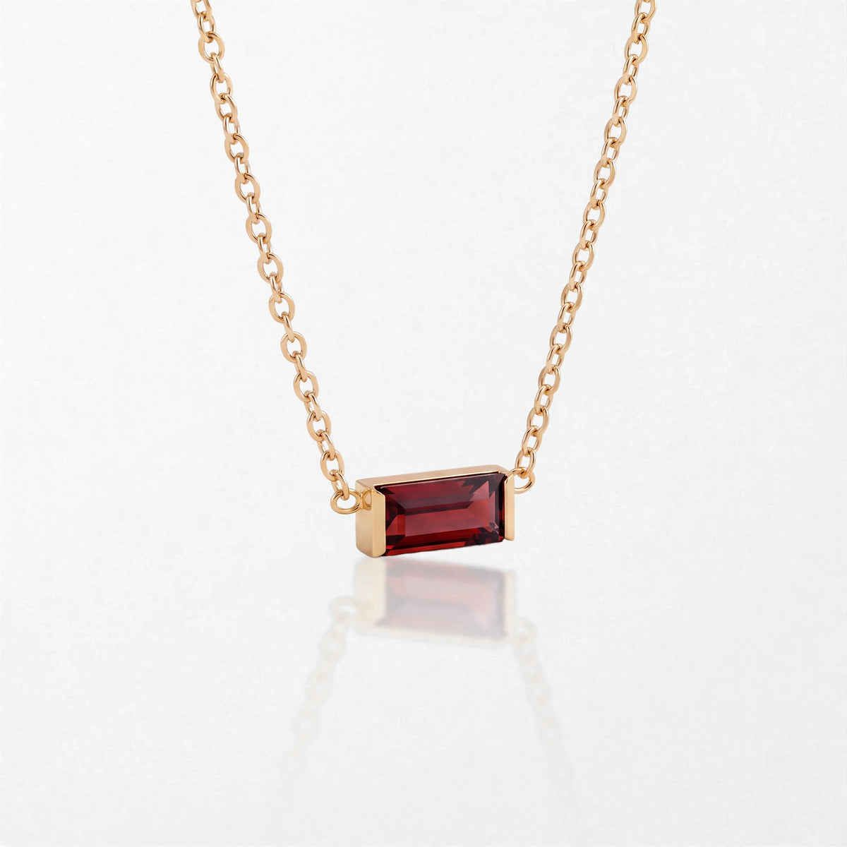 Juno birthstone necklace in 14K gold-plated waterproof stainless steel with a small baguette garnet red stone for January