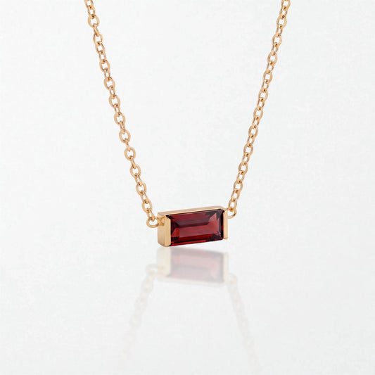 Juno birthstone necklace in 14K gold-plated waterproof stainless steel with a small baguette garnet red stone for January