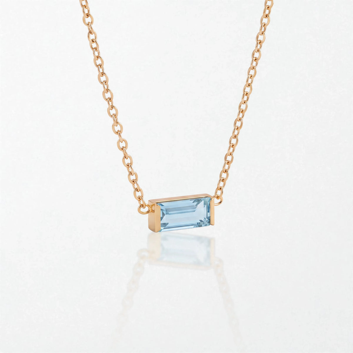 Juno birthstone necklace in 14K gold-plated waterproof stainless steel with a small baguette aquamarine blue stone for March