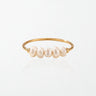 Alva minimalist pearl stacking ring in 18K gold-plated waterproof stainless steel, a thin band with five small freshwater pearls