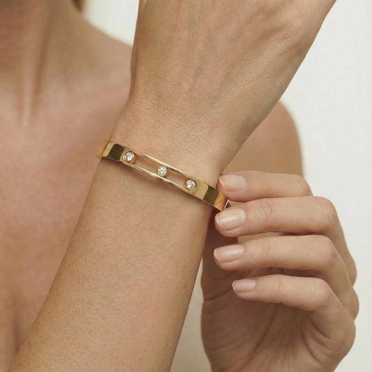 Close up of the central channel featuring three movable cubic zirconia crystals within the 18K gold plated track