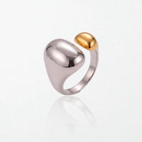 Romy dome ring in duo tone: a large polished silver dome and band with a smaller 18K gold dome