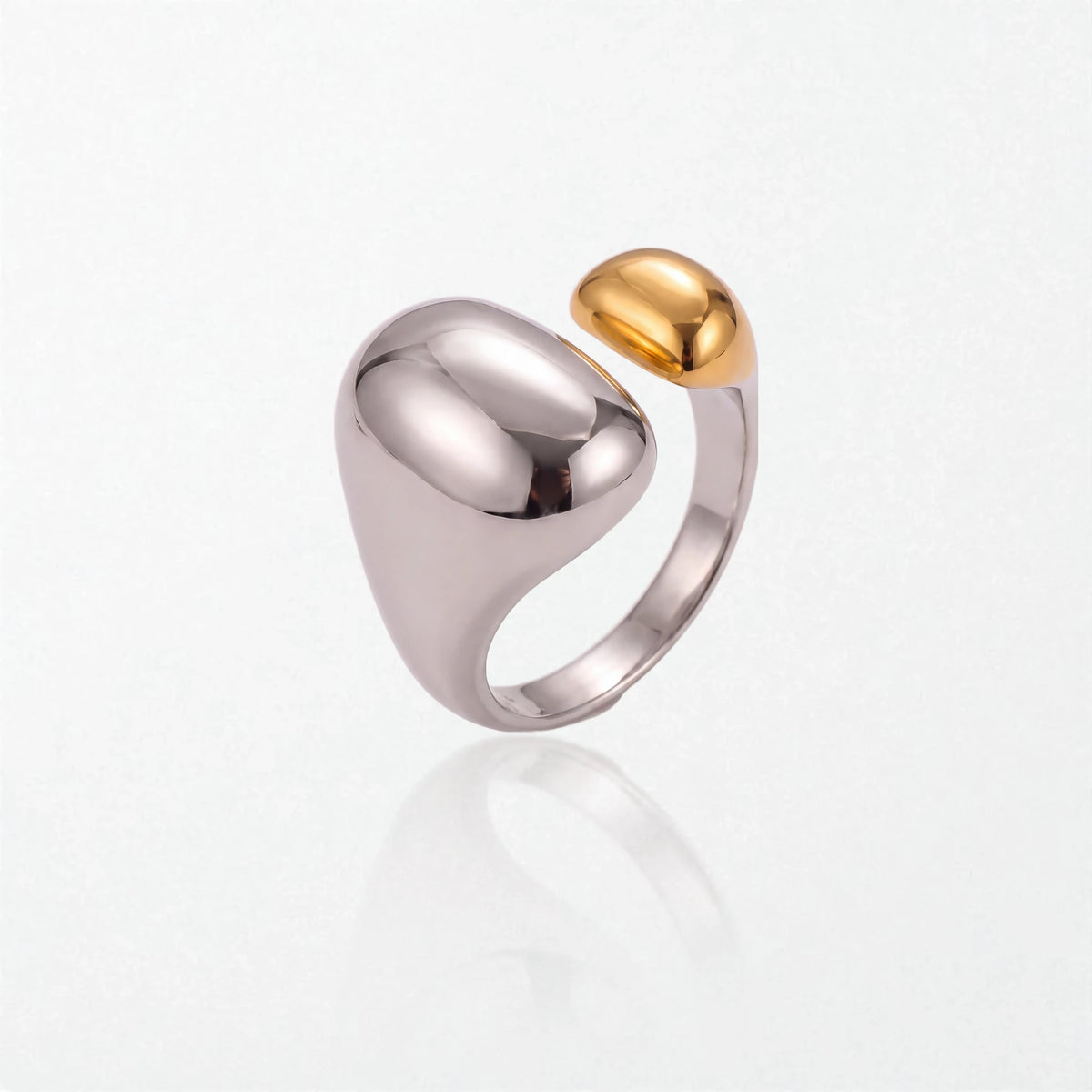 Romy dome ring in duo tone: a large polished silver dome and band with a smaller 18K gold dome