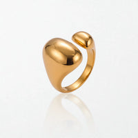 Romy statement ring in 18K gold-plated waterproof stainless steel: a large glossy oval dome facing a smaller dome across an open band