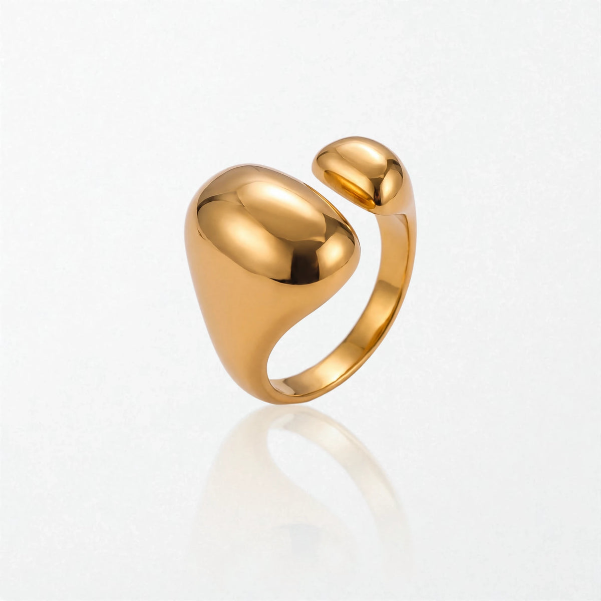 Romy statement ring in 18K gold-plated waterproof stainless steel: a large glossy oval dome facing a smaller dome across an open band
