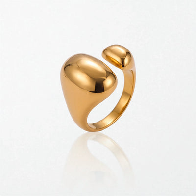 Romy statement ring in 18K gold-plated waterproof stainless steel: a large glossy oval dome facing a smaller dome across an open band
