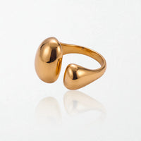 Gold Romy dome ring lying on its side, showing the open adjustable band and both molten domes